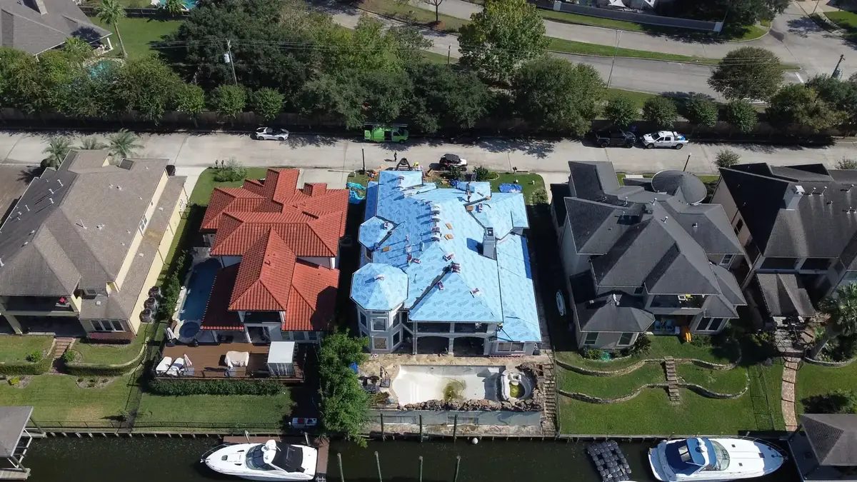 Lakefront home with synthetic underlayment installed, ready for shingles